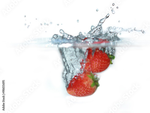 fresh strawberry dropped into water