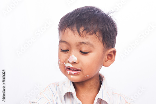 little boy eating cake