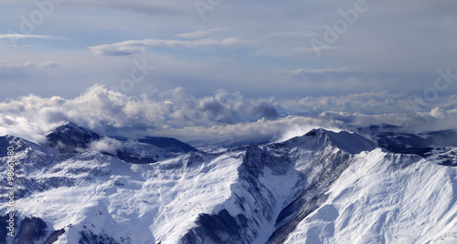Panoramic view on winter mountains in clouds