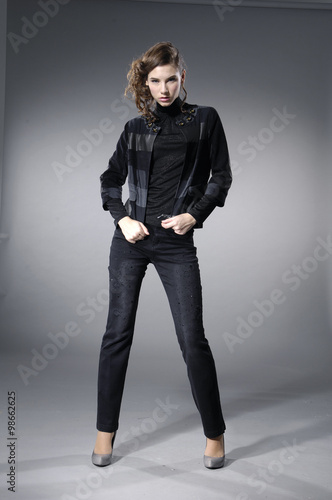 fashion model in modern clothes posing-gray background 