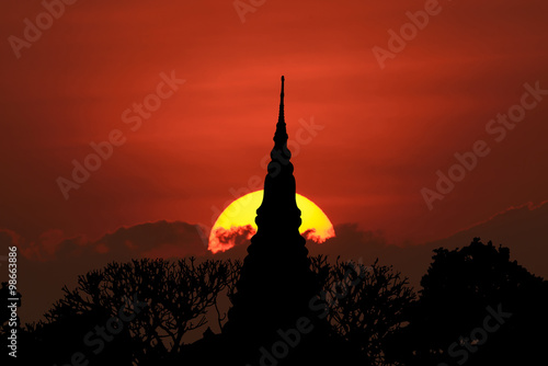 Silhouette Thai Temple with big sun, Petchburi © nuiiko