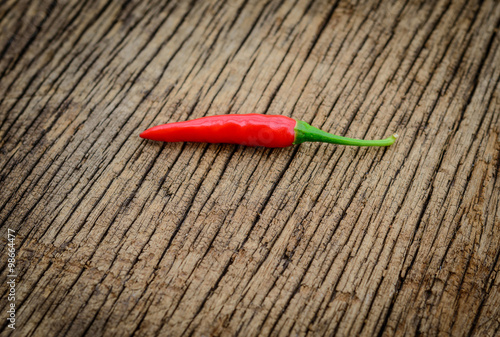 some chili peppers on a wood table