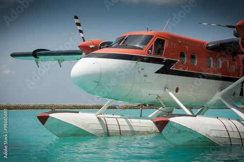 Water taxi aircraft floats in the Indian Ocean by a holiday resort in the Maldives © georgethefourth