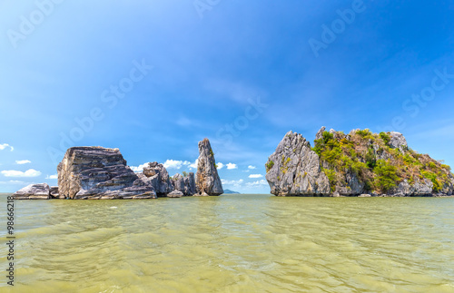 Limestone mountains oceanfront building with high mountains up like giant bonsai located on the sea creating spectacular natural beauty of Vietnam sea