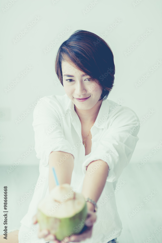 Asian cute girl relax with coconut white room vintage color tone Asian cute girl relax with coconut white room vintage color tone