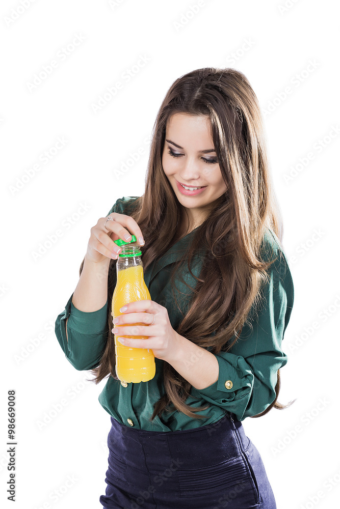 Teenage girl happy while holding a bottle of orange juice.in a green blouse. isolated on a white background.opens a bottle Teenage girl happy while holding a bottle of orange juice.in a green blouse. isolated on a white background.opens a bottle