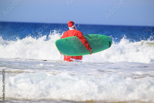 Santa Claus goes surfing.