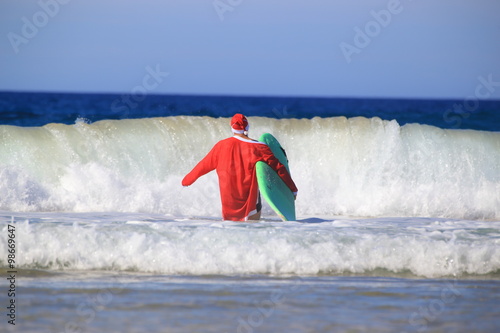 Photography Santa Claus goes surfing.