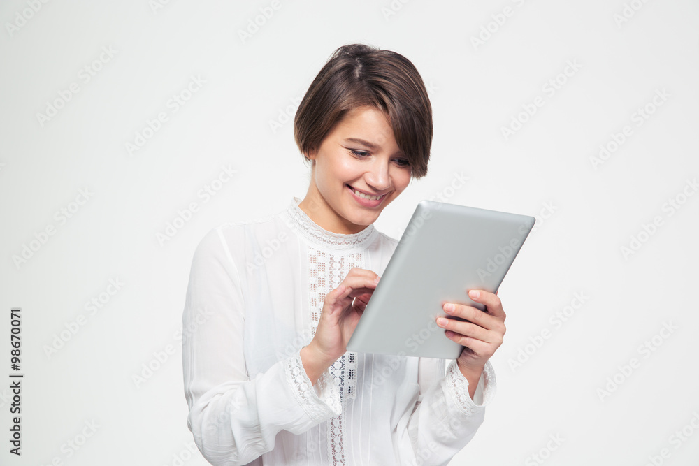 Cheerful attractive young woman using tablet computer