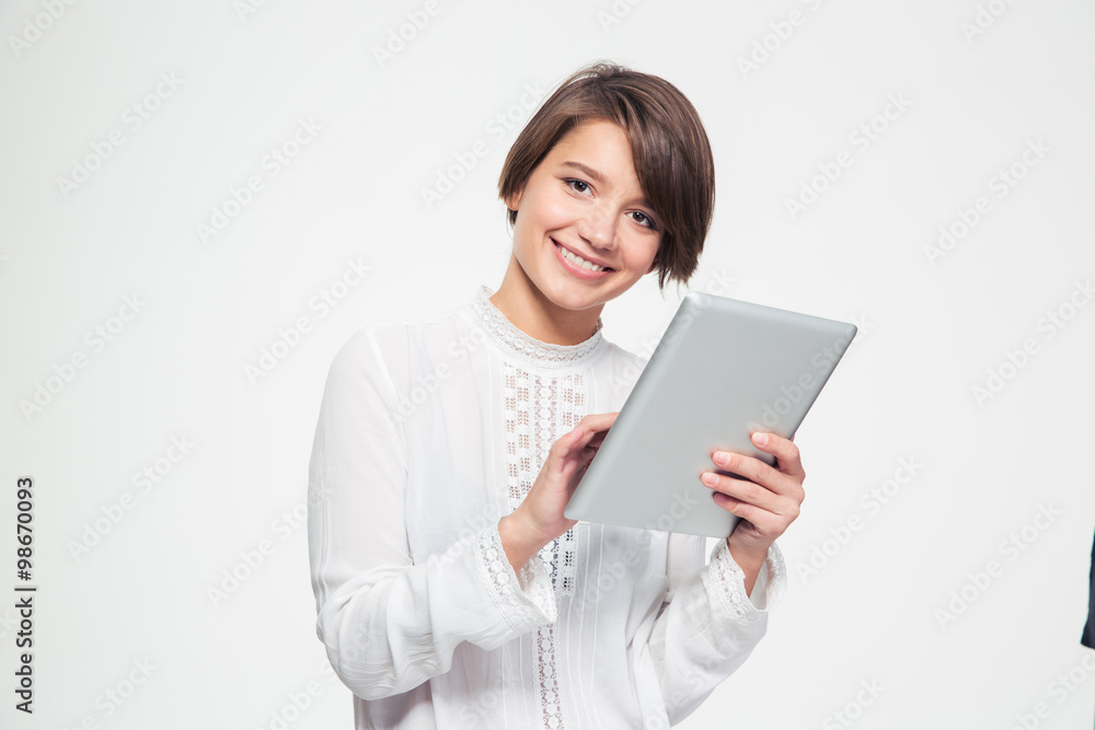 Happy beautiful young woman holding and using tablet Happy beautiful young woman holding and using tablet