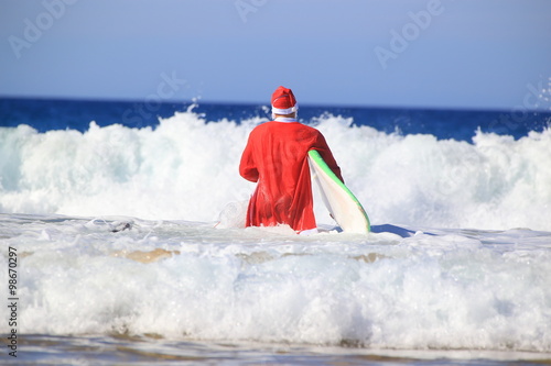 Santa Claus goes surfing.