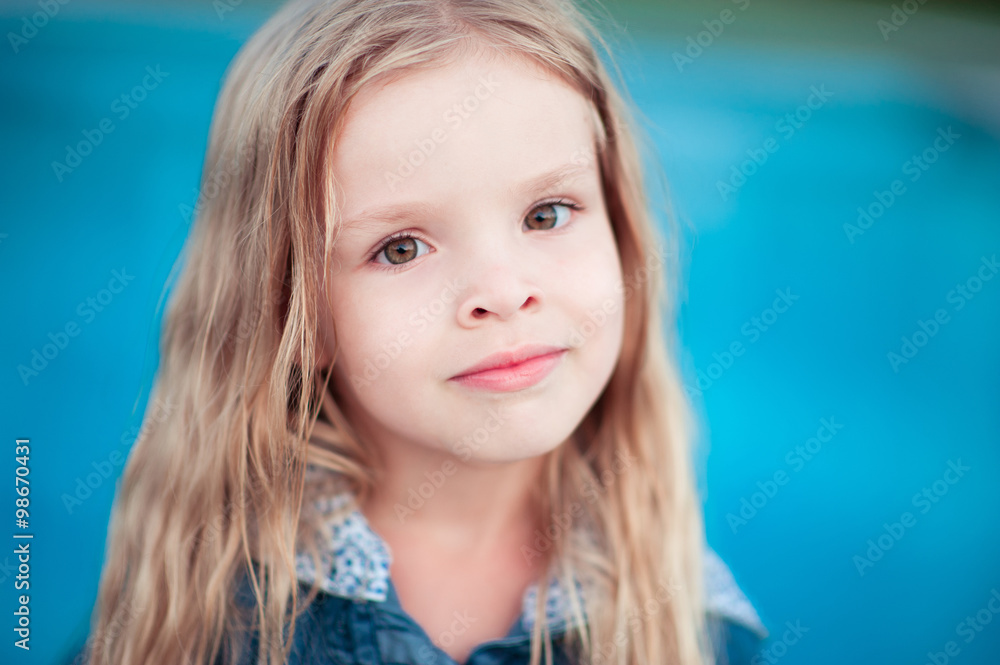 Smiling aby girl 4-5 year old posing over blue. Looking at camera. Childhood. Smiling aby girl 4-5 year old posing over blue. Looking at camera. Childhood.