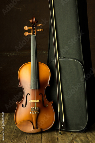 vintage violin resting against an old steel background