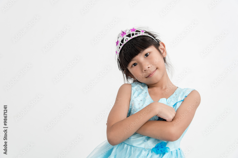 Cute Asian little princess girl in silver crown and blue dress o Cute Asian little princess girl in silver crown and blue dress o