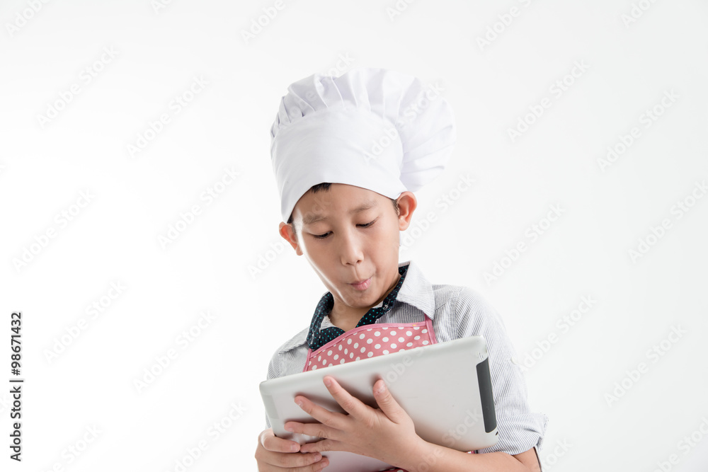 Young Asian Cook Touching Tablet Isolated on gray background. Young Asian Cook Touching Tablet Isolated on gray background.
