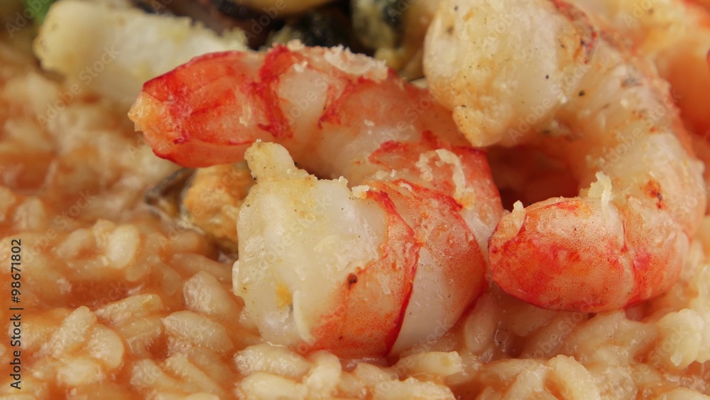 Shrimps, mussels and squid closeup on a plate of rice (risotto) Shrimps, mussels and squid closeup on a plate of rice (risotto)