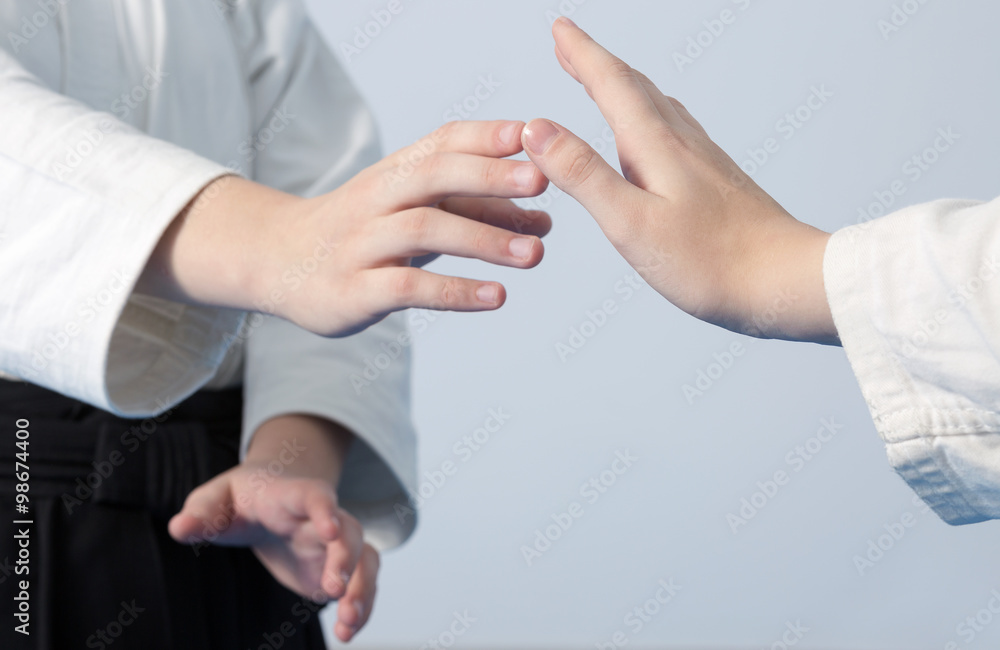 Hands of two girls standing in stance on martial arts training
