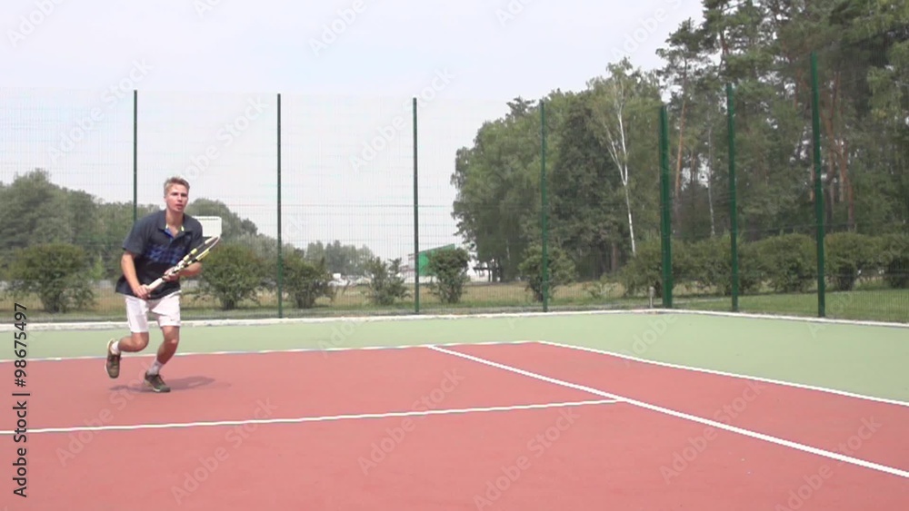 Tennis player uses backhand slice on the half court. Slow motion Tennis player uses backhand slice on the half court. Slow motion