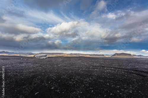 Airplane wreckage on black sand beach. Douglas Dakota DC3, US na photo