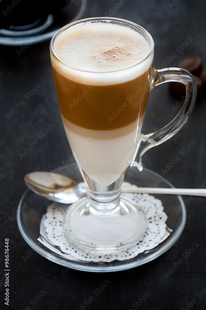 Latte Macchiato with chocolate on dark wooden table Latte Macchiato with chocolate on dark wooden table