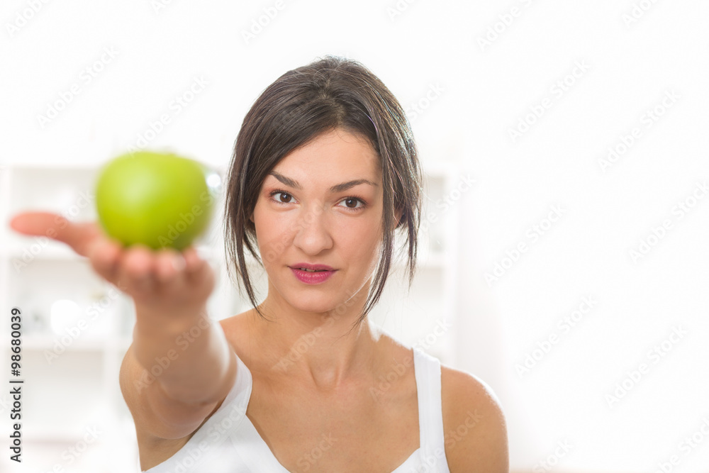 Beautiful girl holding an apple on the palm of her stretched hand Beautiful girl holding an apple on the palm of her stretched hand