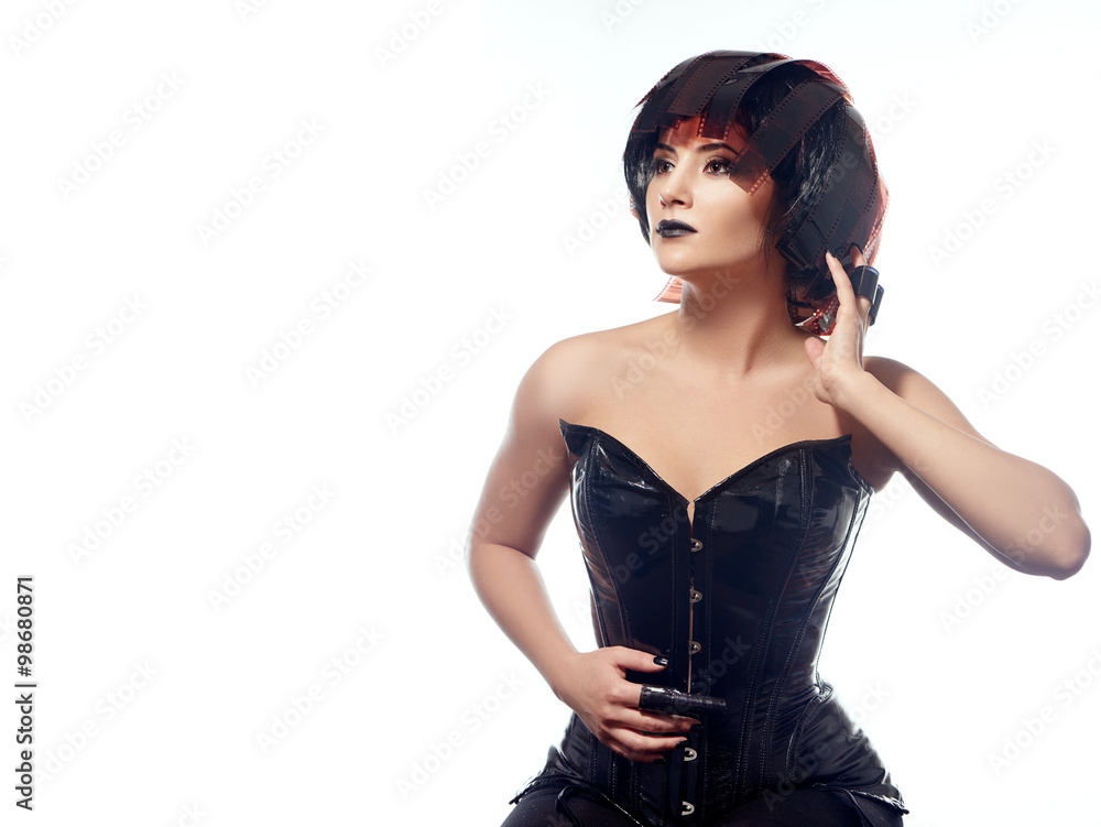 Beautiful stylish woman in leather corset and filmstrips wig isolated on white background Beautiful stylish woman in leather corset and filmstrips wig isolated on white background