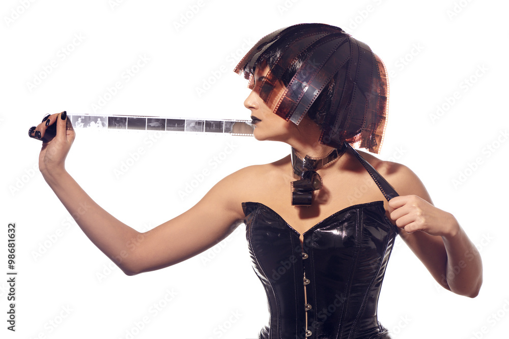 Beautiful stylish woman in leather corset and filmstrips hairstyle posing isolated on white background Beautiful stylish woman in leather corset and filmstrips hairstyle posing isolated on white background