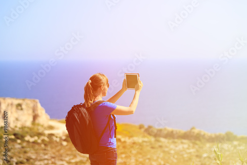 young tourist making photo using touch pad