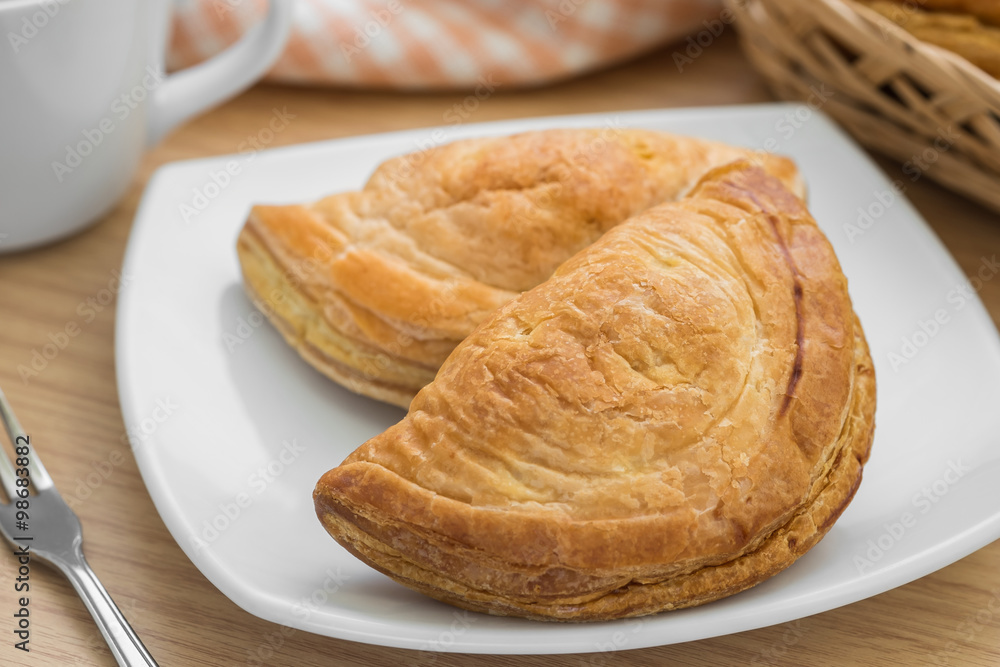Puff pastry on plate and coffee cup Puff pastry on plate and coffee cup