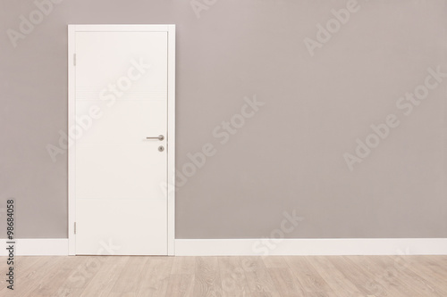 White door in an empty room