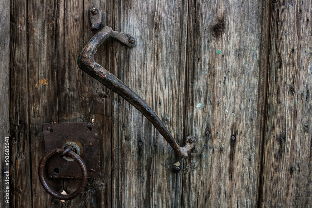 Old wooden door with wrought iron handle Old wooden door with wrought iron handle