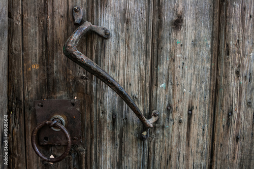 Old wooden door with wrought iron handle