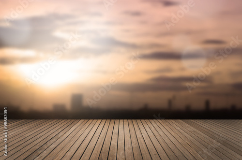 Aerial view of blurred cityscape with abstract background of morning gold sunrise light with brown wood floor