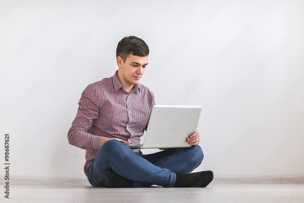 A young man working on a laptop A young man working on a laptop