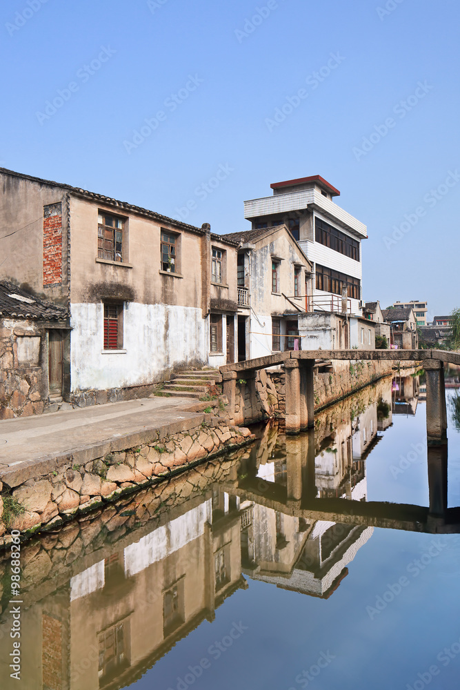 Row of traditional style houses reflected in a canal, Wenzhou, Zhejiang Province, China