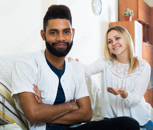 White girl and afro guy trying make out after argue photo