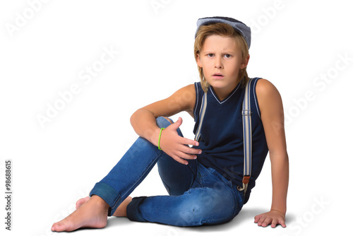 Cute blonde agresivny boy or teenager in full length casual style blue jeans posing isolated on white