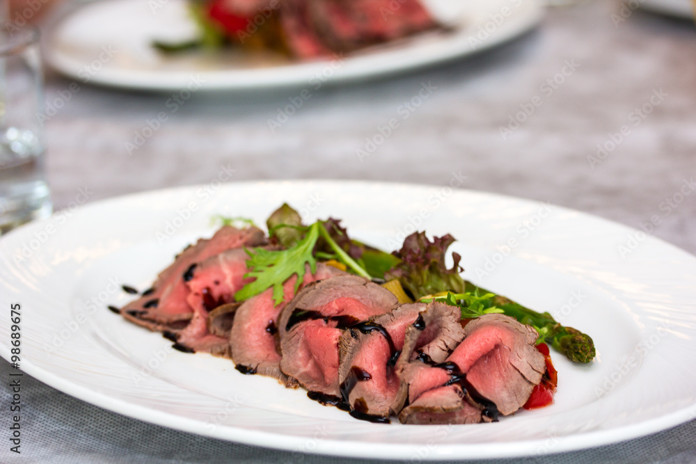 Roast beef is on the plate. Roast beef is on the plate.