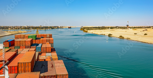 Industrial container ship passing through Suez Canal with ship's