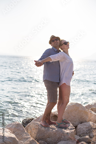 Young happy romantic couple having fun on the sandy tropical bea
