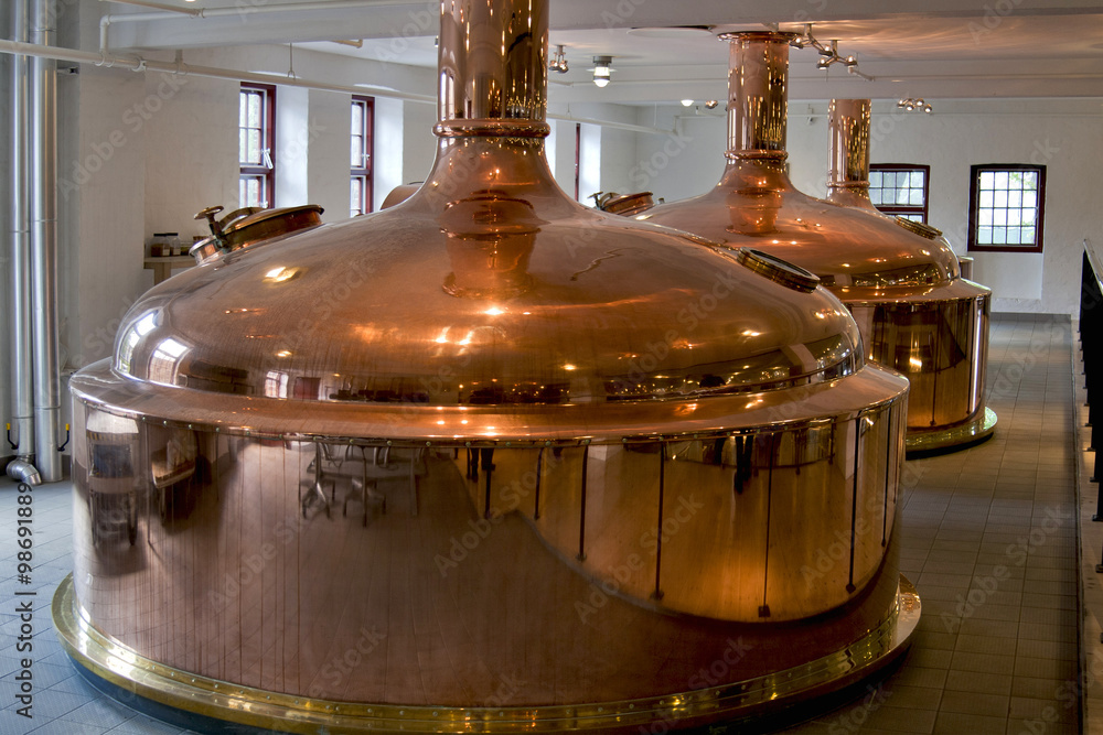 Copper distillery tanks in old brewery. StockFoto Adobe Stock