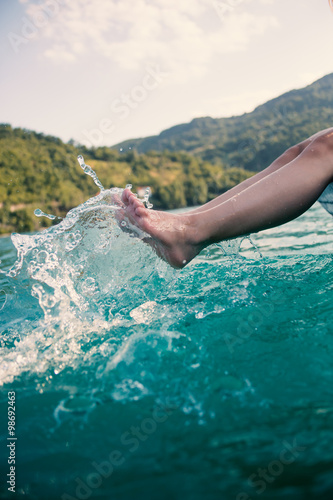 girl s beauty legs in the lake making splashes