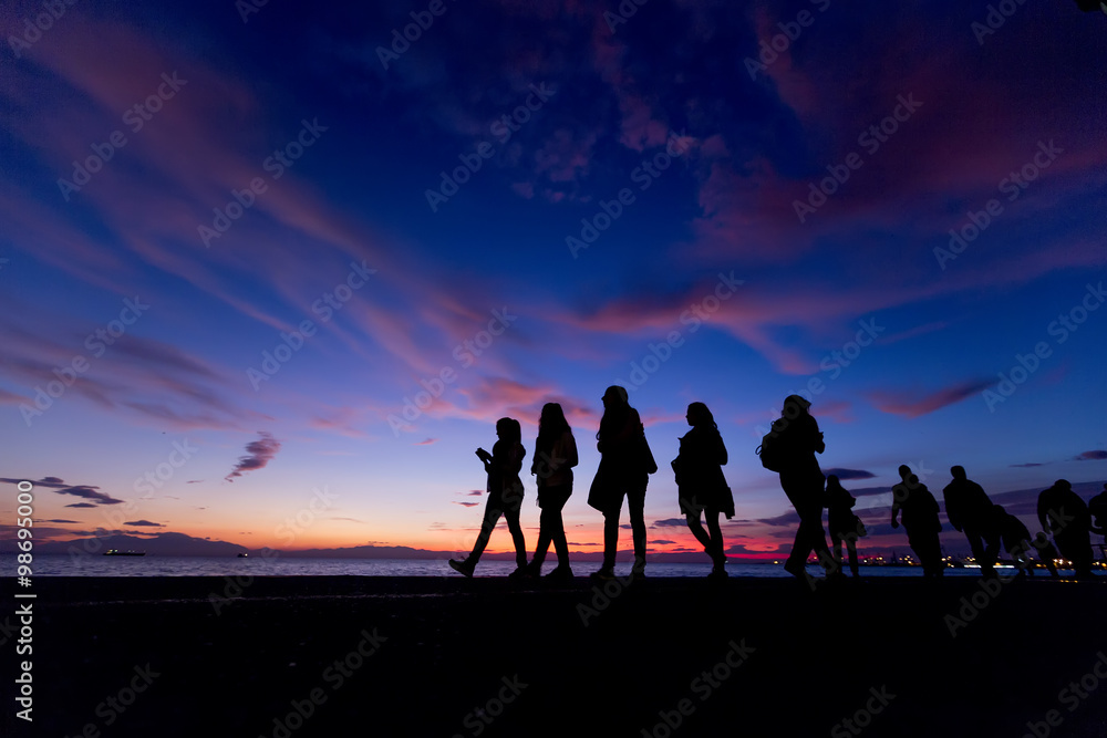 The Silhouettes are doing Activities on the Beach at Sunset The Silhouettes are doing Activities on the Beach at Sunset