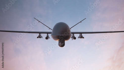 Military predator drone flying at sunset. Armed intelligent unmanned vehicle.