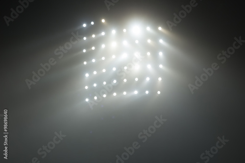 Bright white and yellow Stadium lights with fog