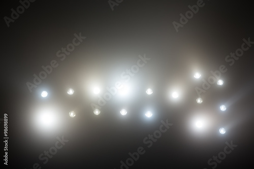 Bright white and yellow Stadium lights with fog. Defocused image