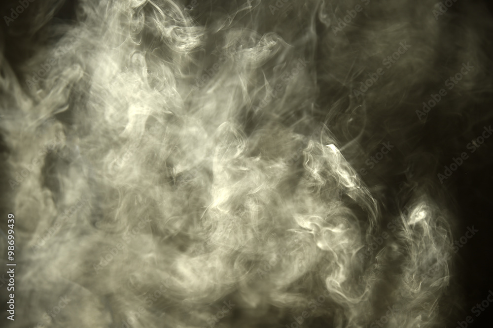 Smoke through the ray of light in a dark room
Smoke through the ray of light in a dark room