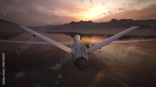 Military predator drone flying at sunset. Intelligent unmanned vehicle.
