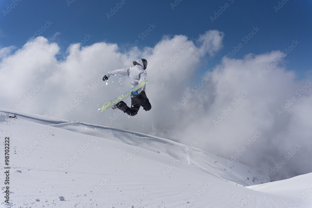 Flying snowboarder on mountains. Extreme sport. Flying snowboarder on mountains. Extreme sport.