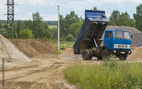 Dump truck unloads construction sand